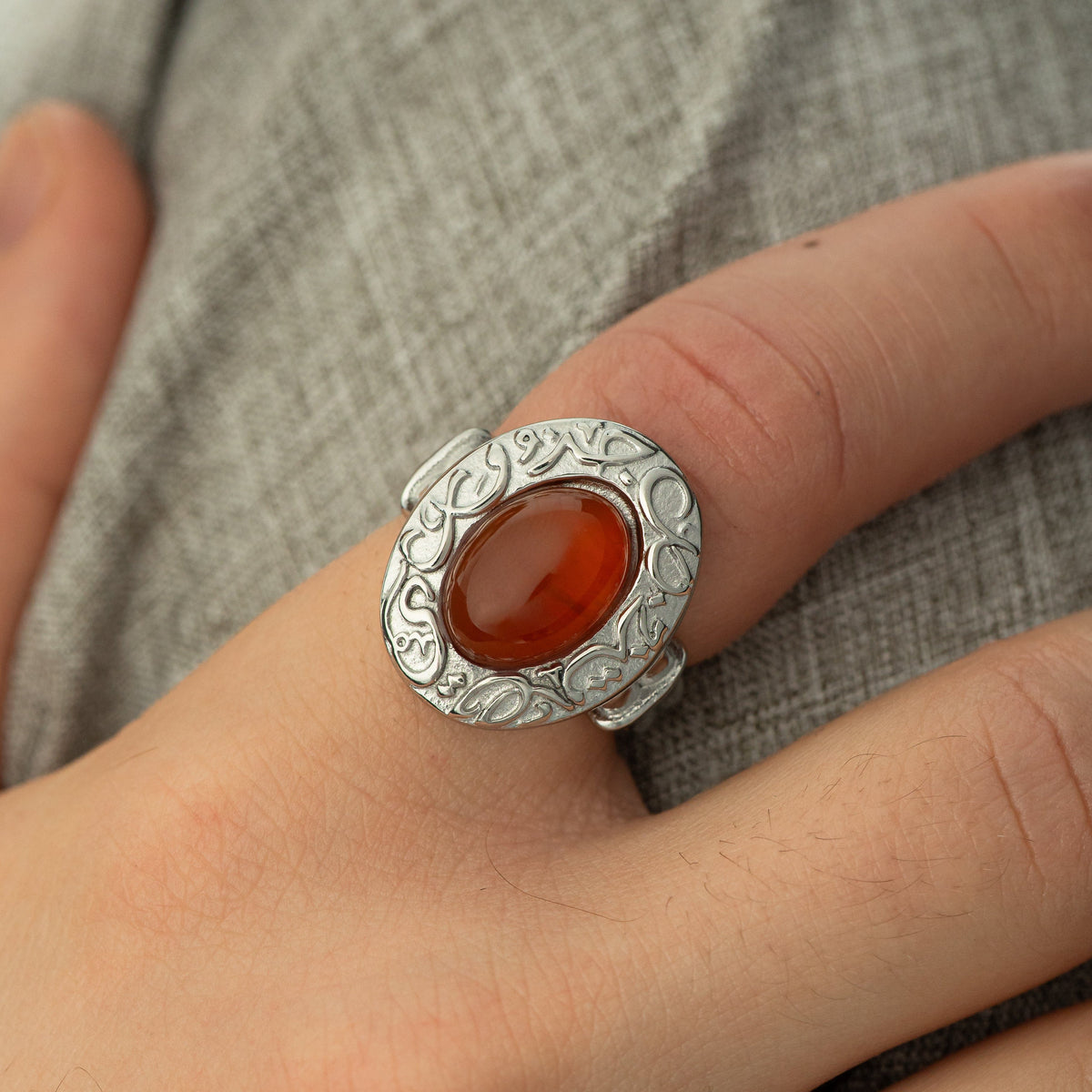 Close up photo of the model's right hand wearing the silver Roots Don't Fade Stone Ring | Men on their right index finger.