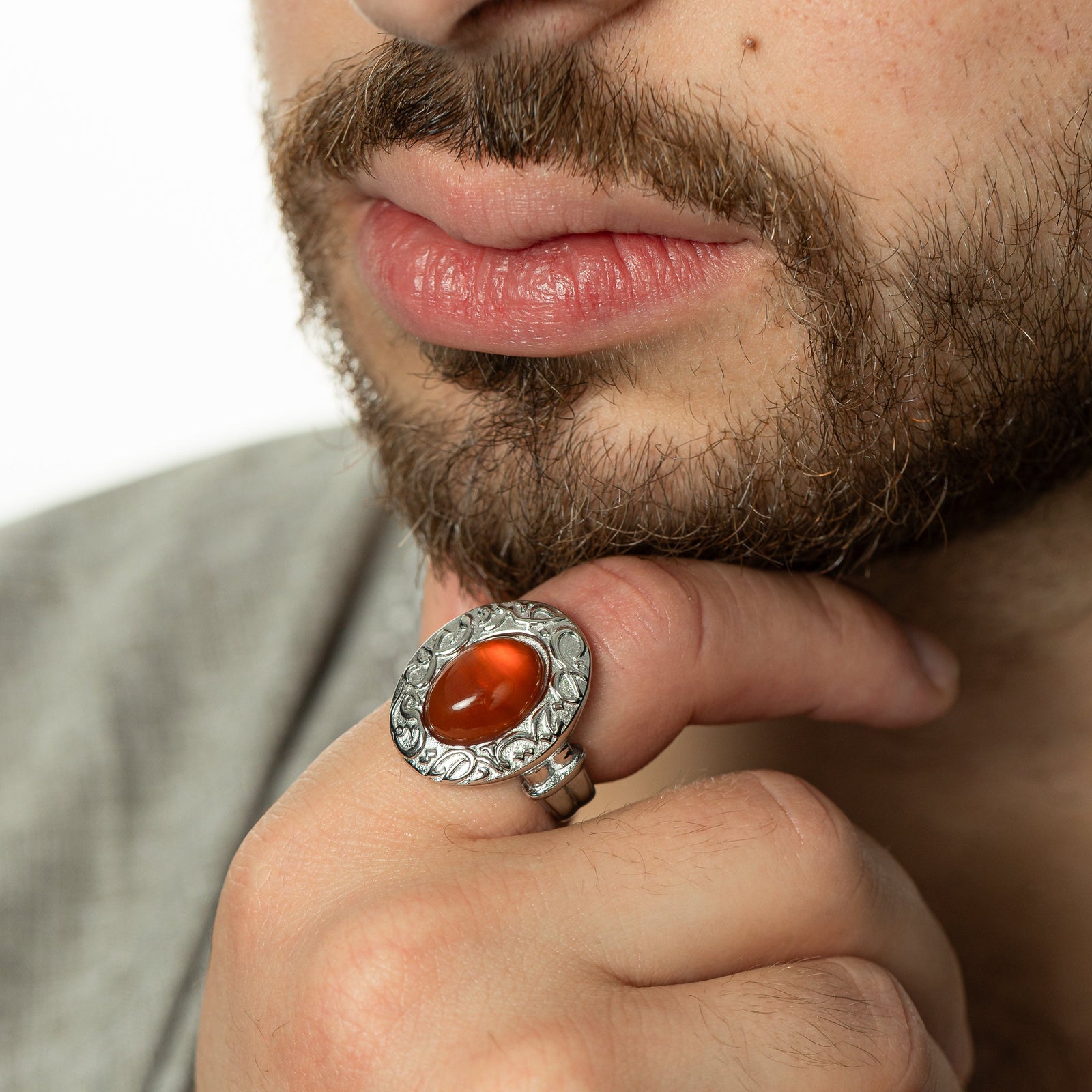 Model touching their chin with their right hand, wearing the silver ring on the index finger.
