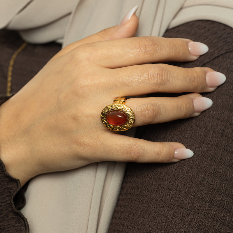 Hand wearing the Roots Don’t Fade Stone Ring in gold