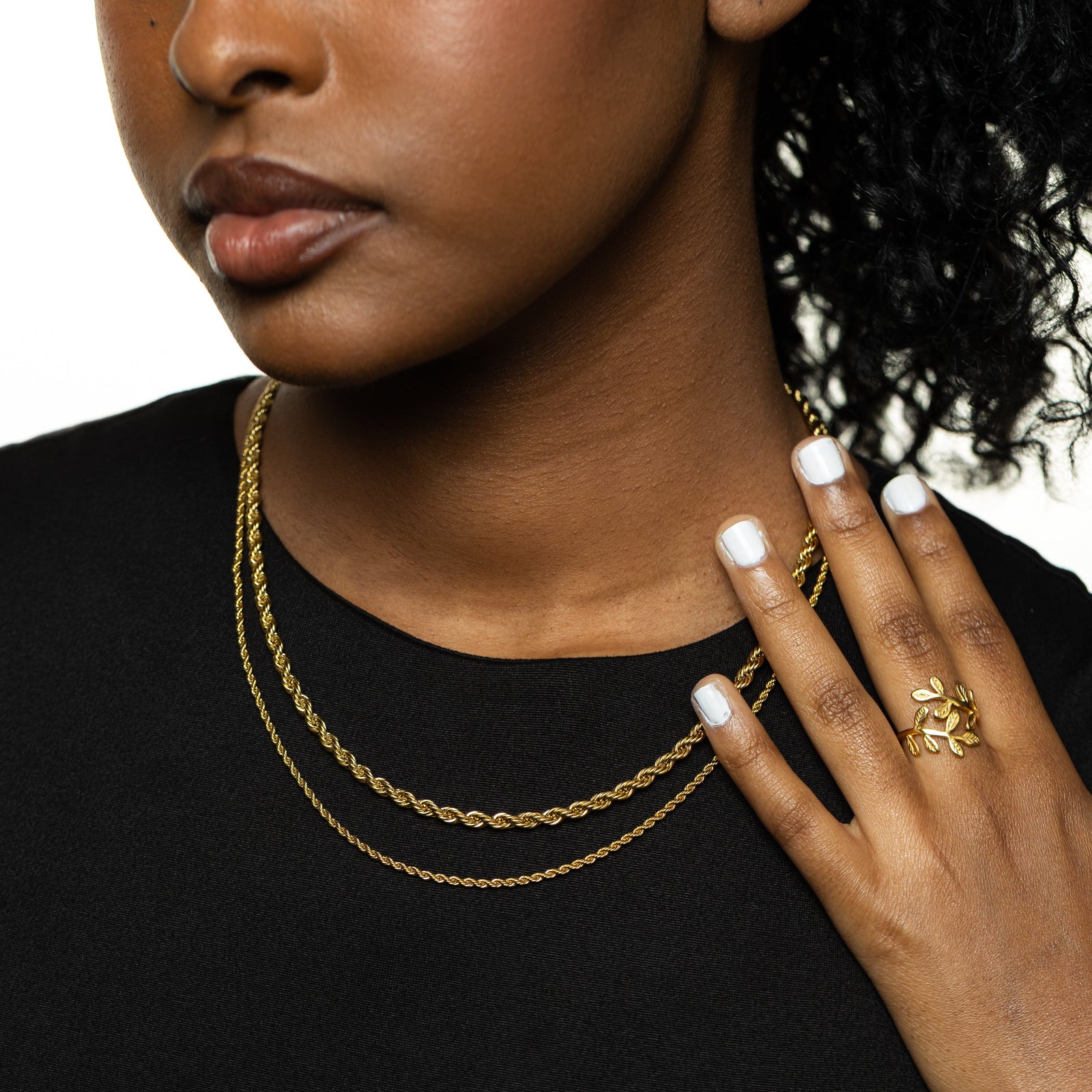 Close up of the gold Rope Chain Necklaces in different thickness as worn by the model.