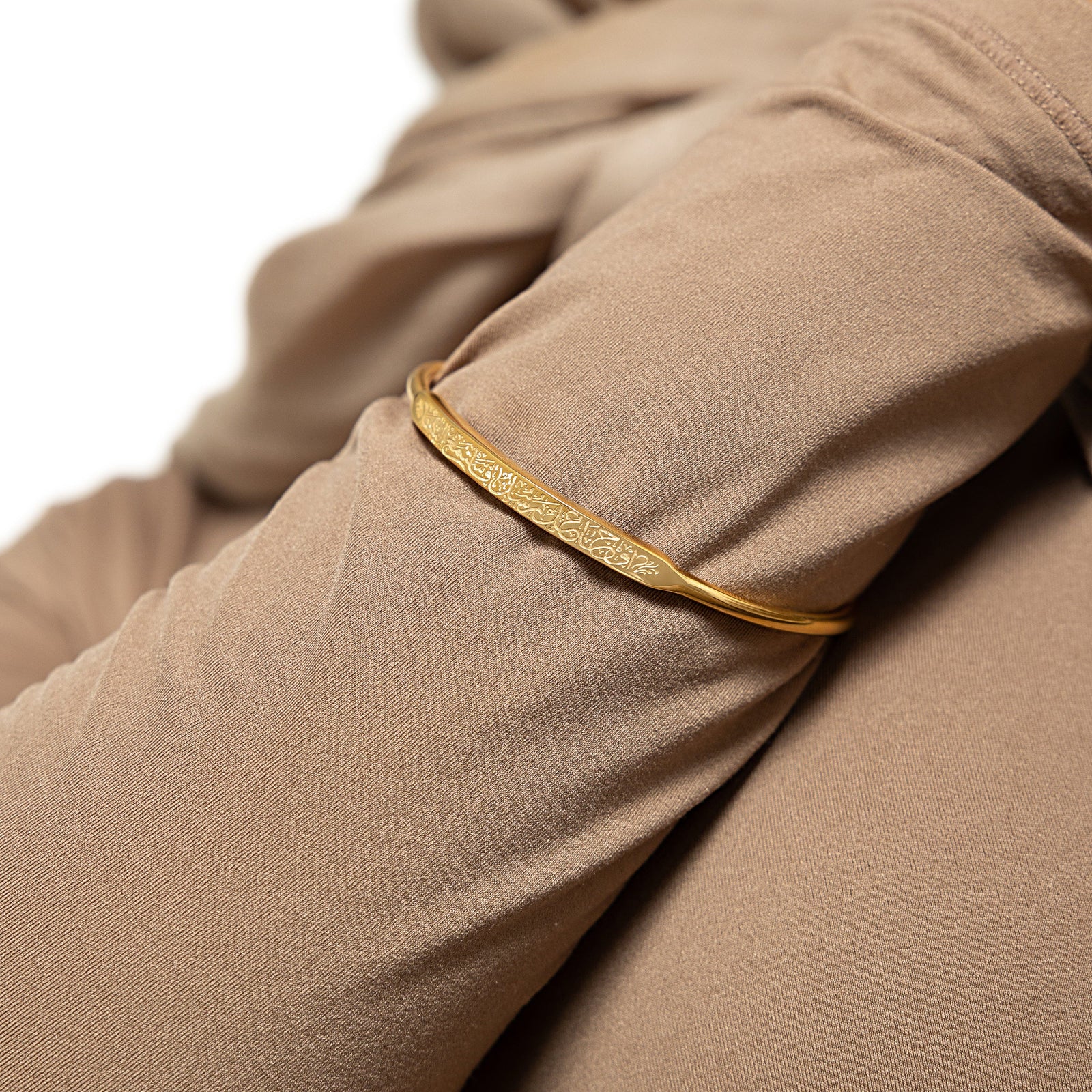 The bangle worn on a model's wrist, demonstrating its fit and the visibility of the engraved quote.