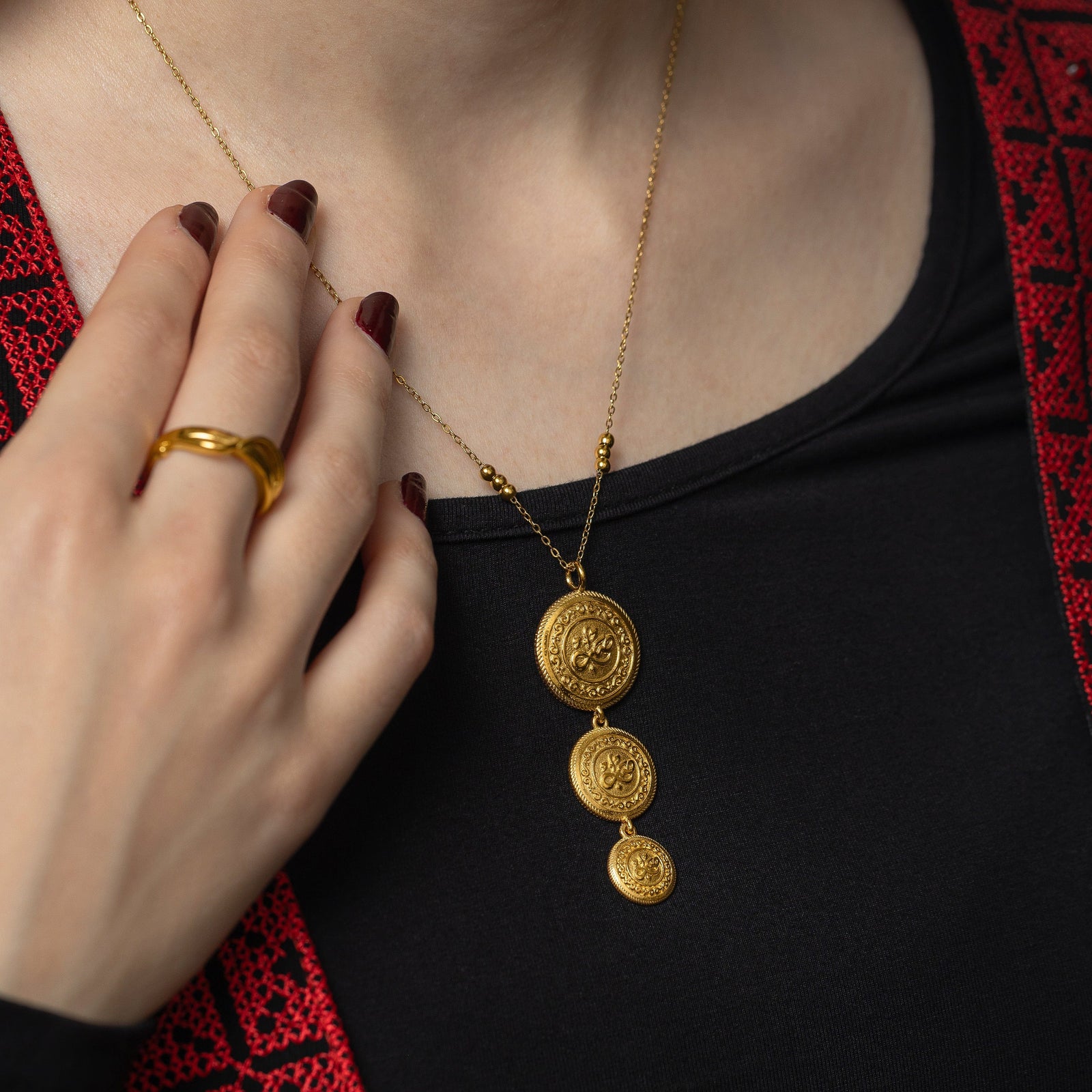 Photo of he gold Sabr | Patience Coin Necklace worn by a model.