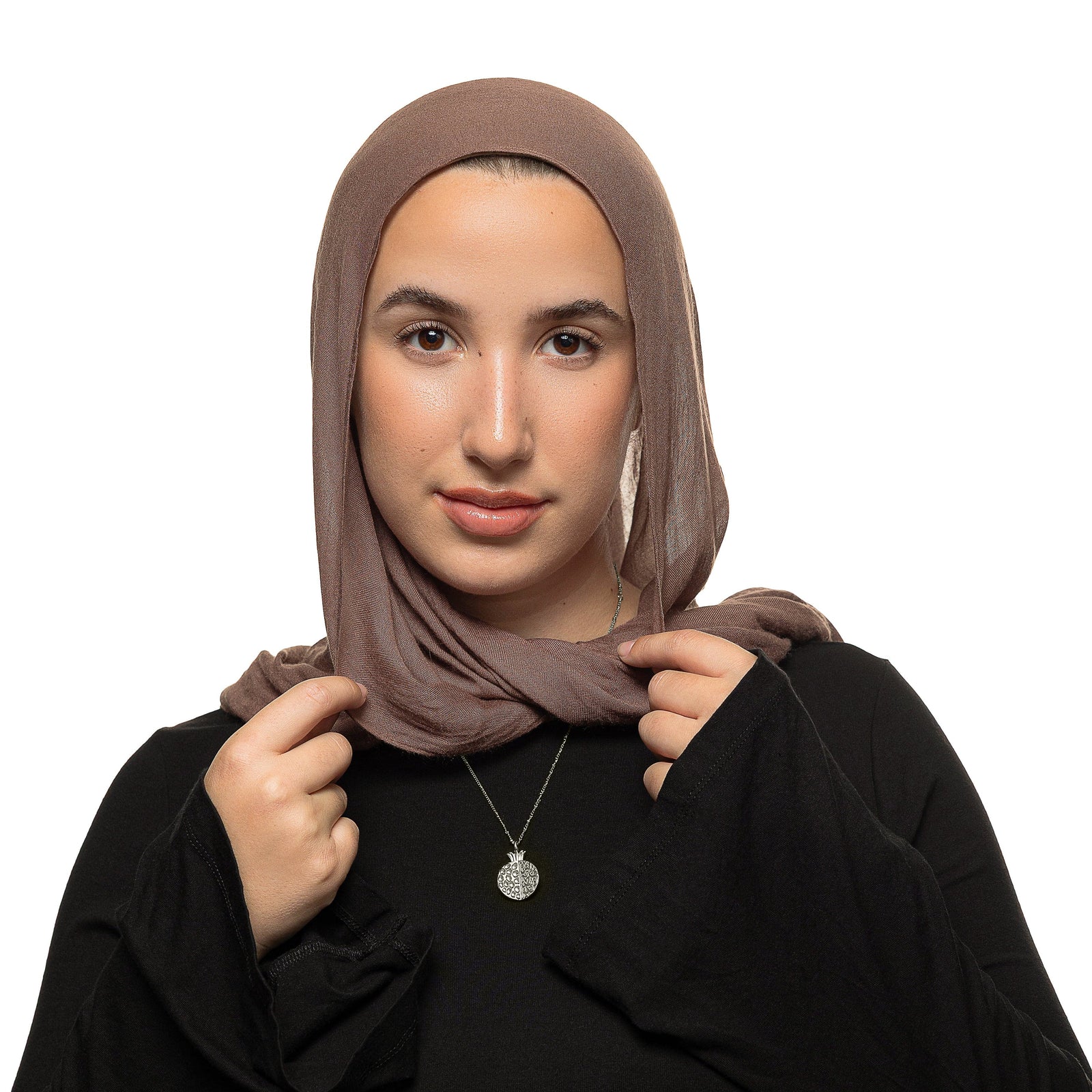 Model wearing the silver Seeds of Gratitude Necklace over a black top with a brown hijab.