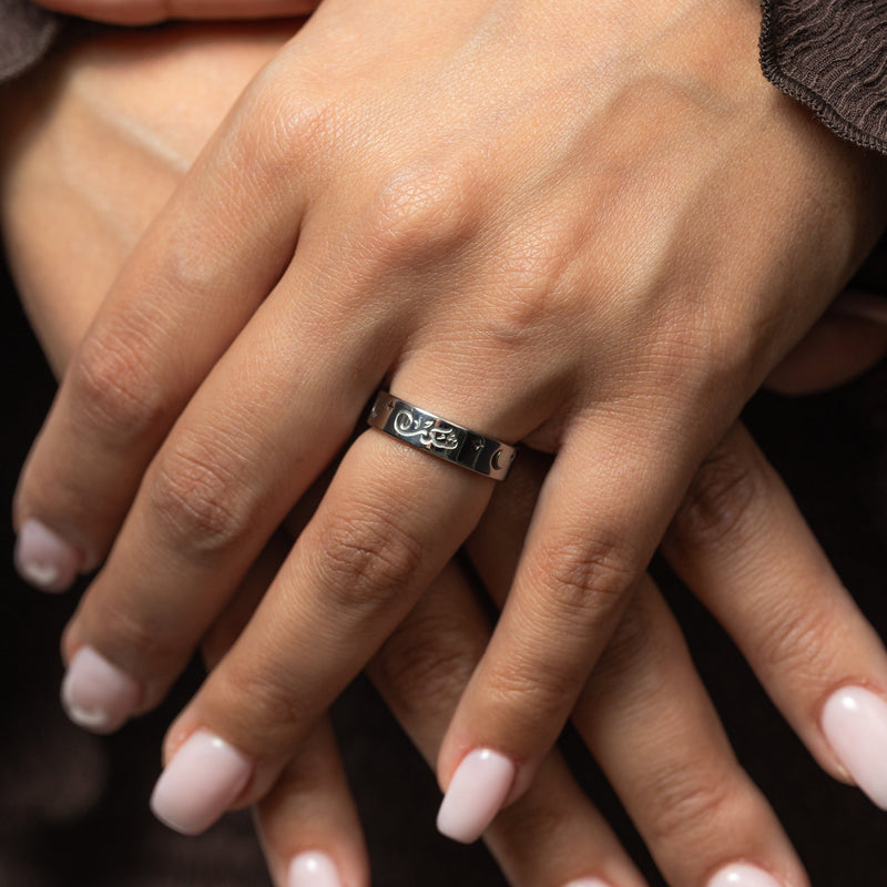 Close-up of a hand wearing a silver Shukr | Gratitude ring