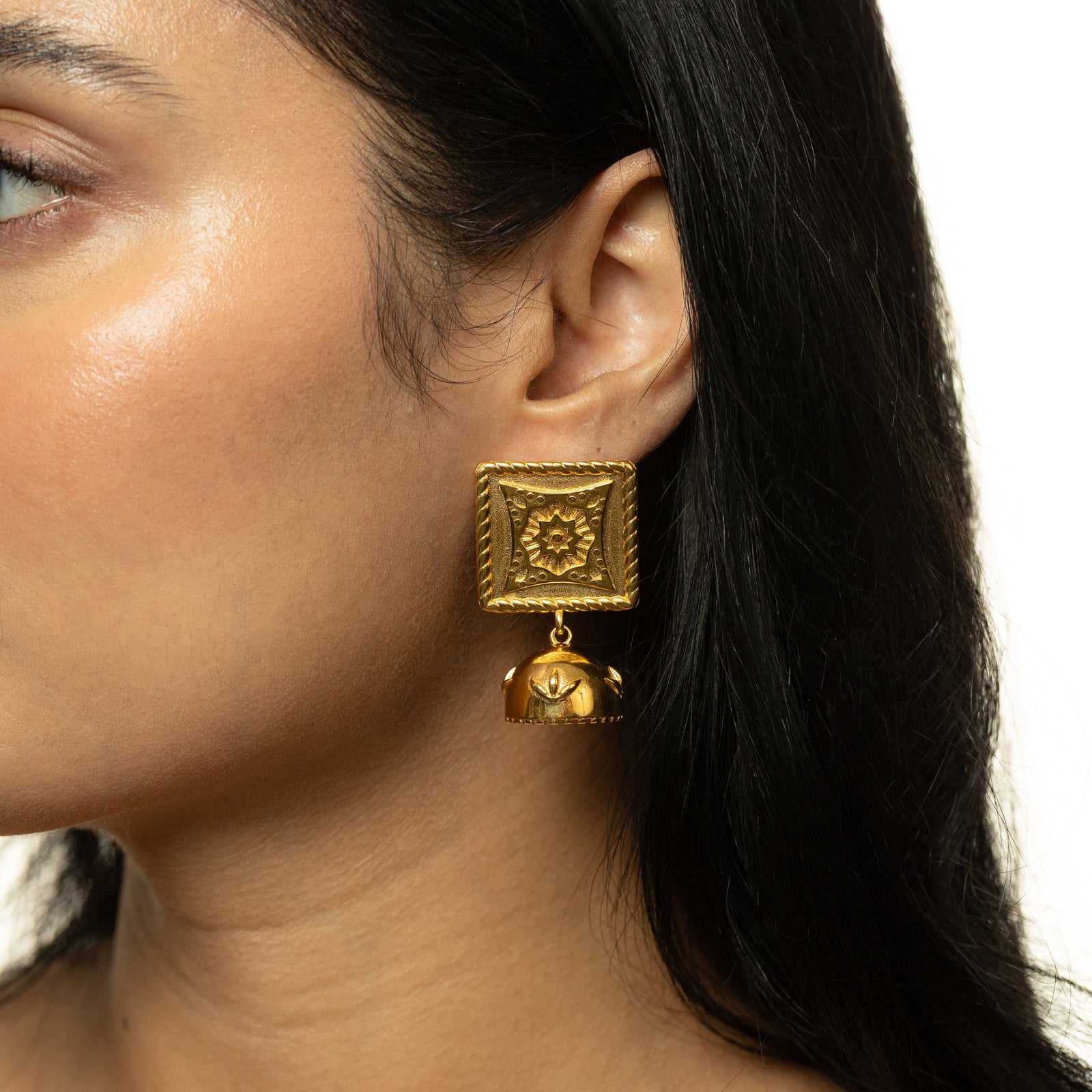 a woman wearing the gold Square Jhumka Earring.