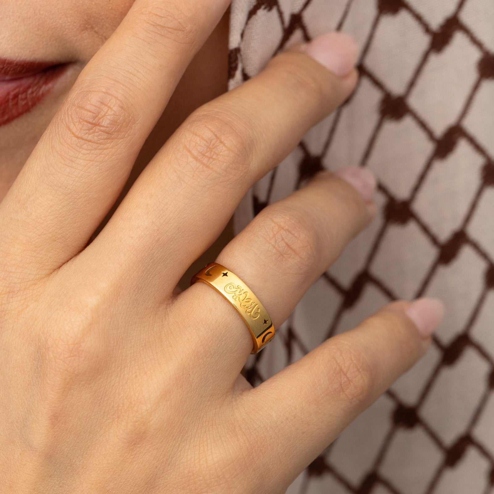 Gold Starlit Palestine ring on a finger