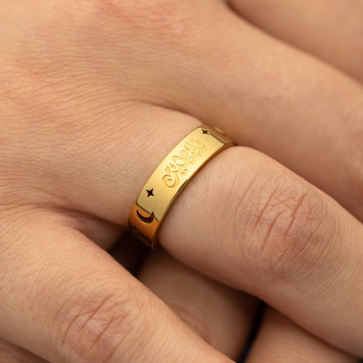 Gold Starlit Palestine ring on a finger