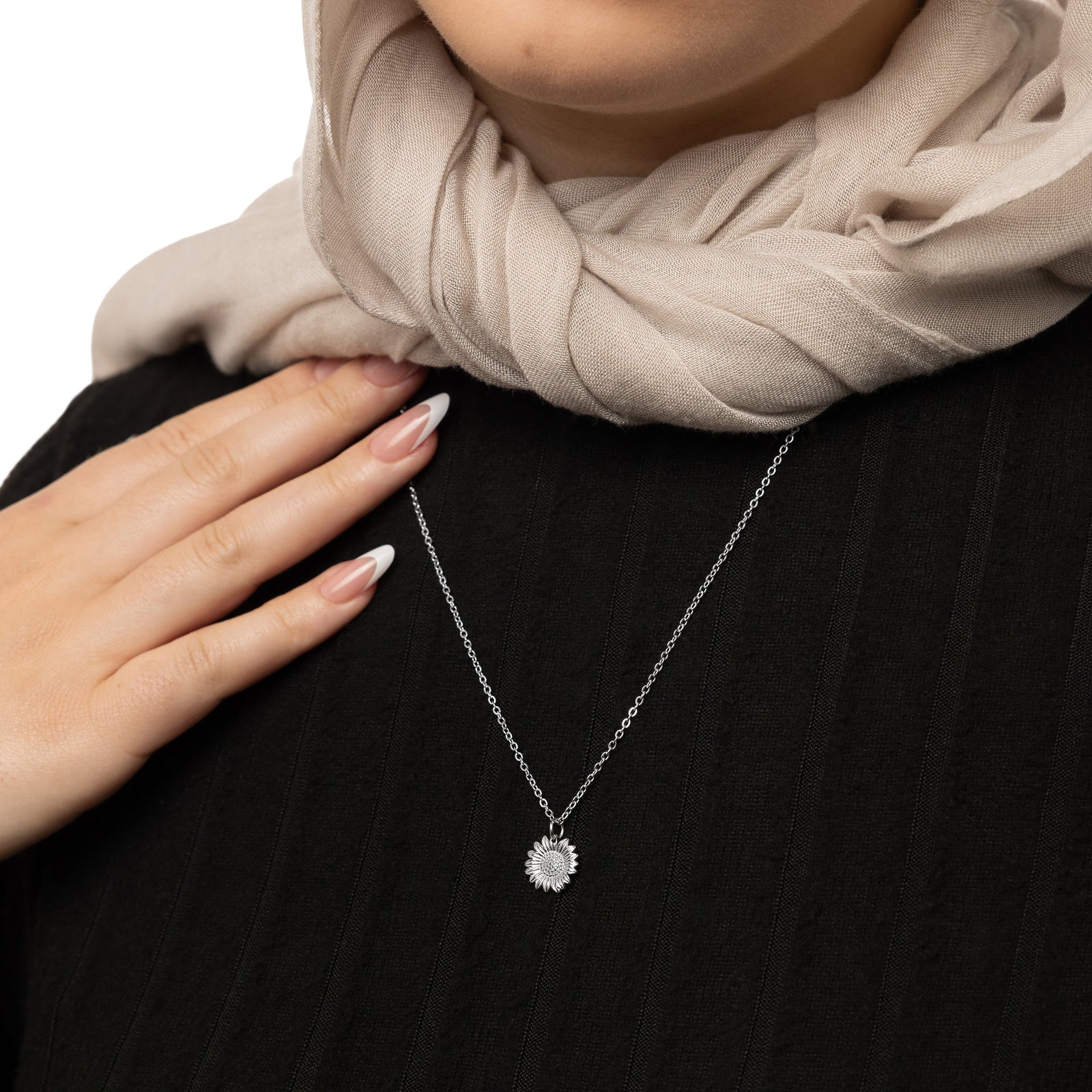 Close up of the Silver Sunflower Necklace as worn by the model.