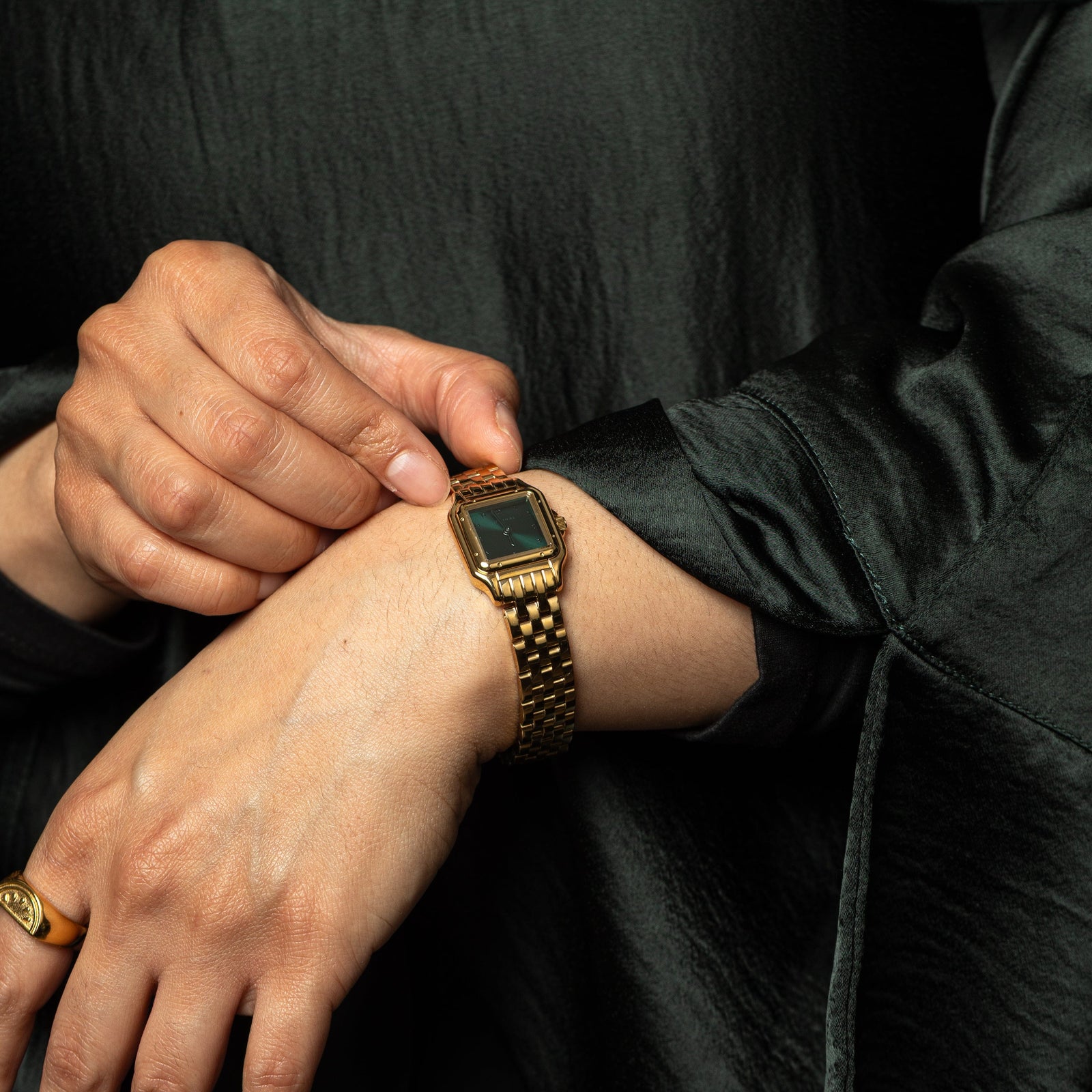 Model adjusting the Aurora watch on their left wrist.