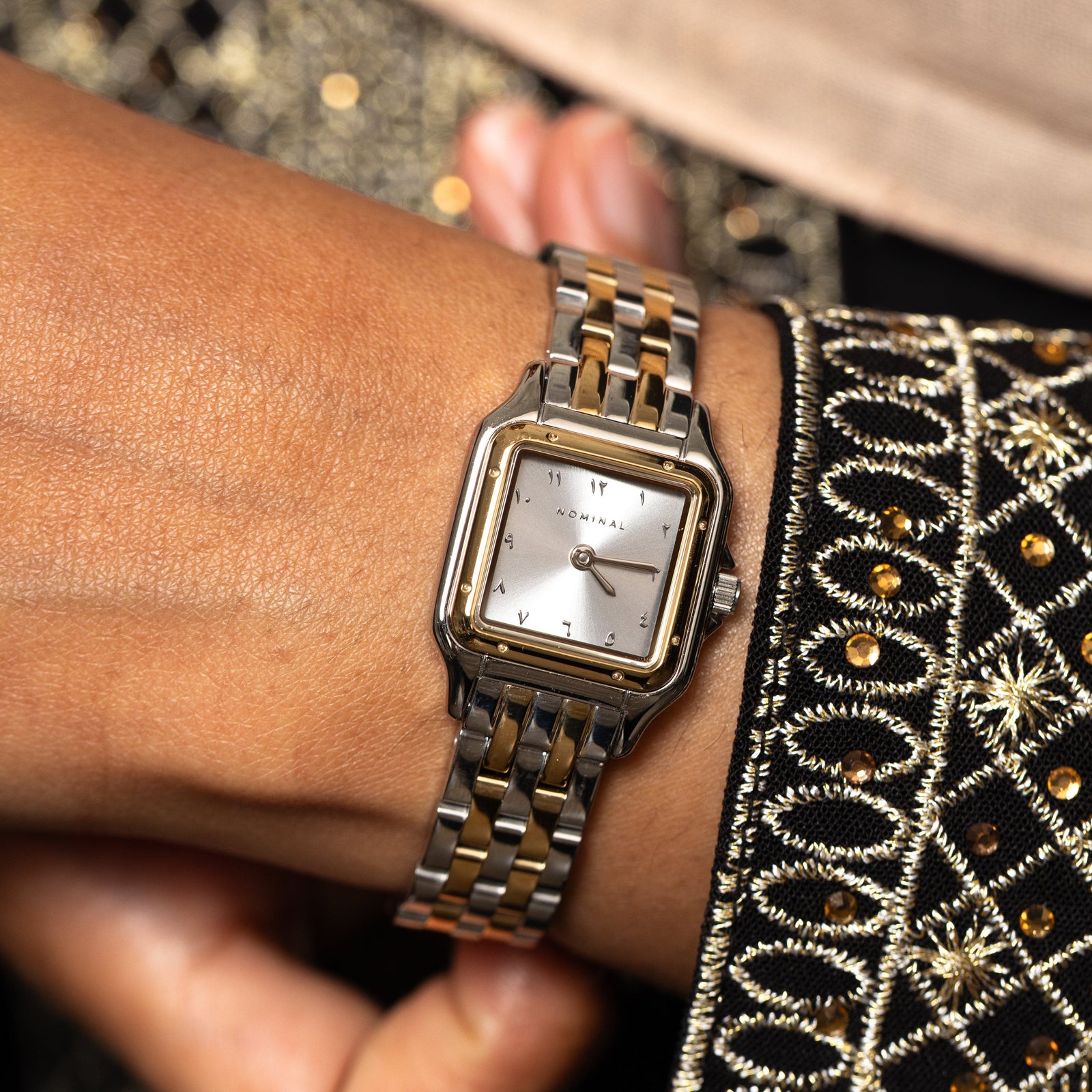 Close up photo of the face of the Sunrise watch as worn by the model