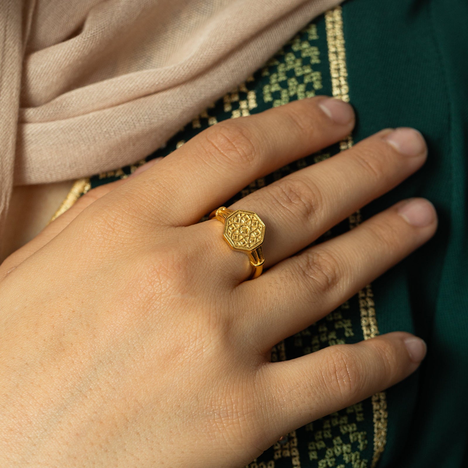 Photo of the model's hand wearing the gold Syrian Mosaic Ring