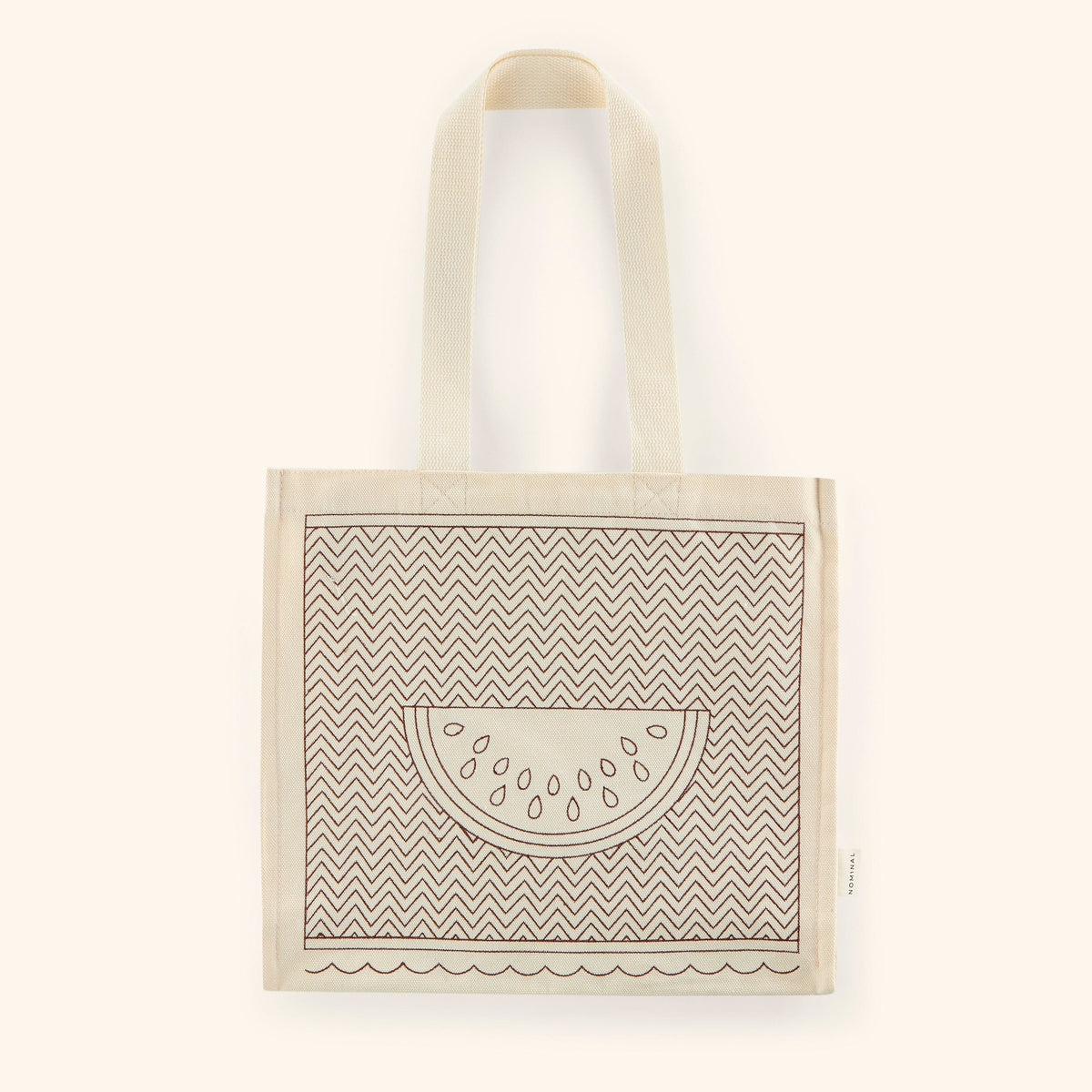 Photo of the textured cotton canvass with a watermelon art stitched on the middle with a lined pattern along the canvas.