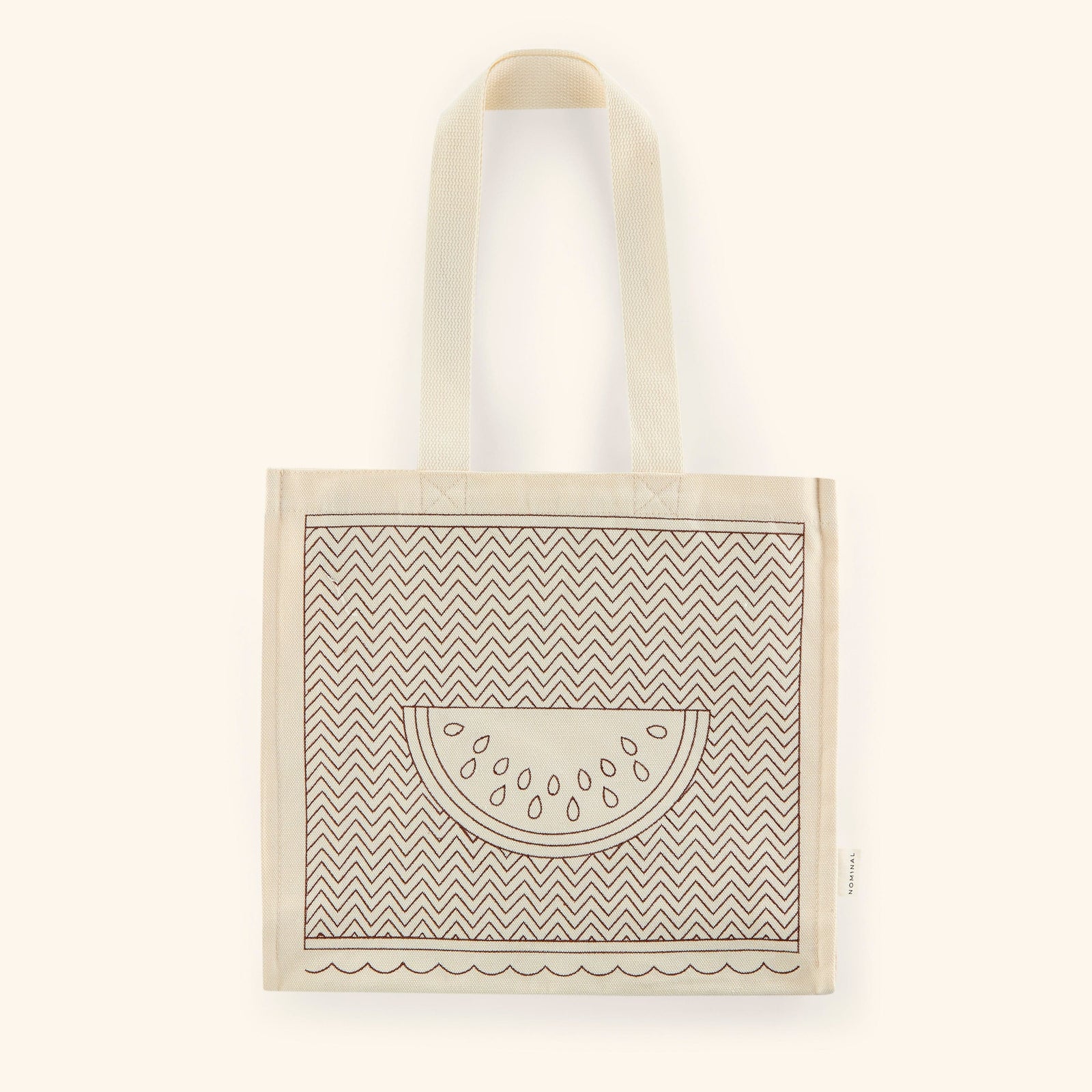 Photo of the textured cotton canvass with a watermelon art stitched on the middle with a lined pattern along the canvas.
