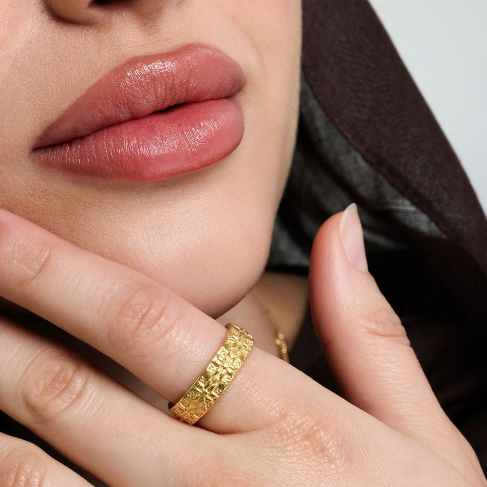 Close up of the gold Tatreez Ring as worn by the model.