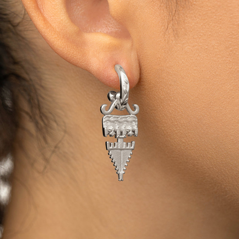 Silver Tatreez Earring with a textured geometric drop worn on a woman's ear in a close-up shot.