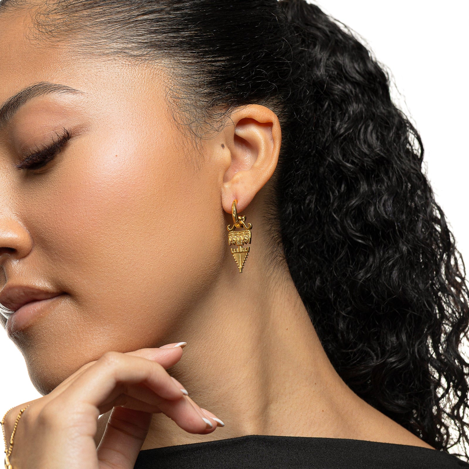 Gold Tatreez Earring with a textured geometric drop worn on a woman's ear.