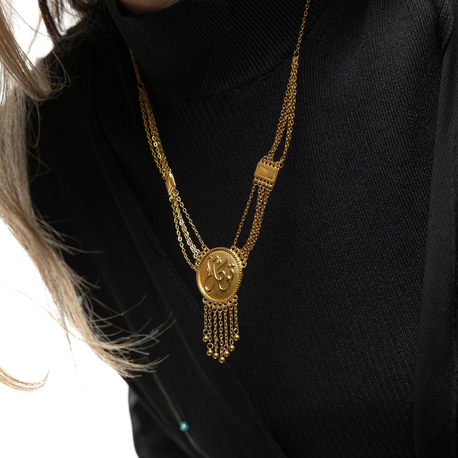 Close up photo of the gold Tawakkul | Trust Draping Necklace as worn by the model.