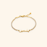 18k gold-plated Tennis Name Bracelet featuring a clear pavé crystal chain with a central custom Arabic calligraphy nameplate.