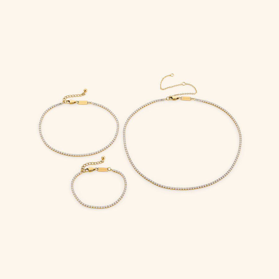 18k gold-plated Tennis Set featuring the Tennis Necklace, Tennis Anklet, and Tennis Bracelet.