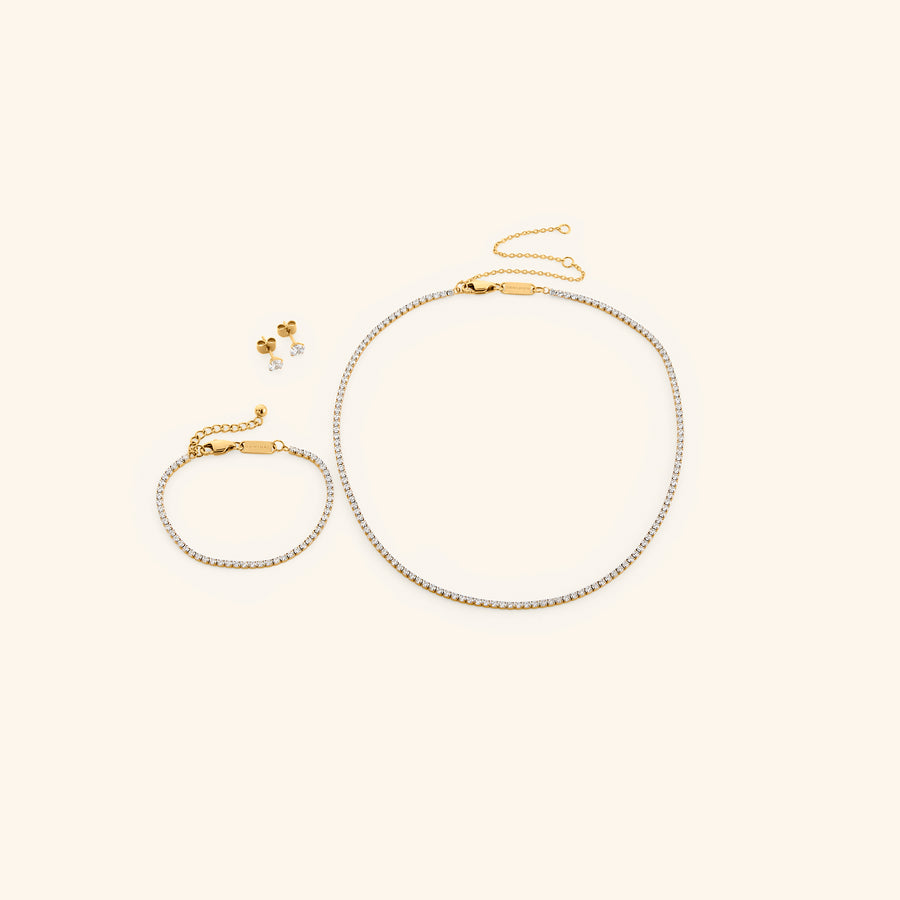 18k gold-plated Tennis Set featuring the Tennis Necklace, Tennis Bracelet, and Tennis Earrings.