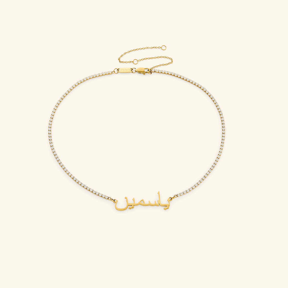18k gold-plated Tennis Name Necklace featuring a clear pavé crystal chain with a central custom Arabic calligraphy nameplate.