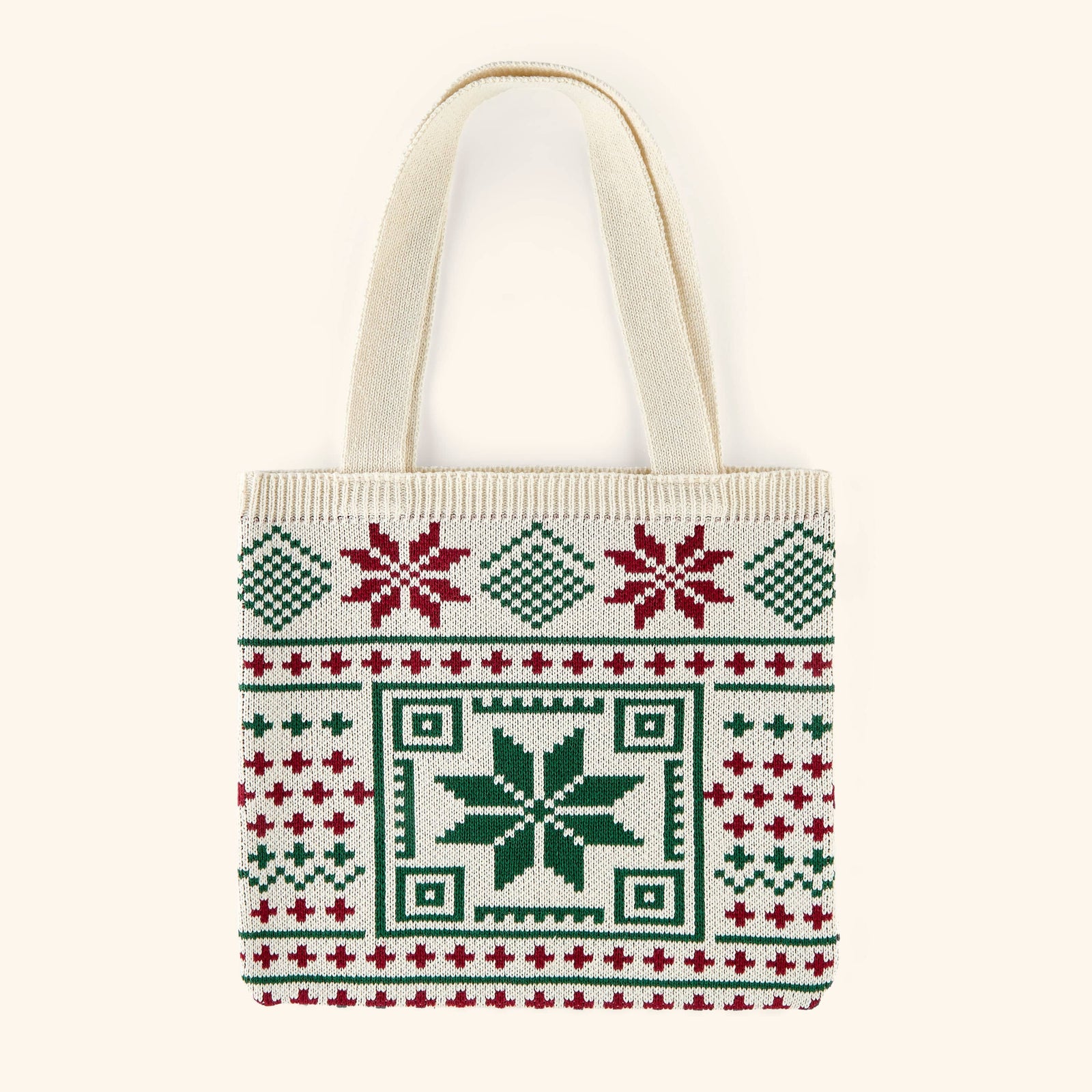 A knit cotton canvass tote woven with tatreez motifs in red and green.