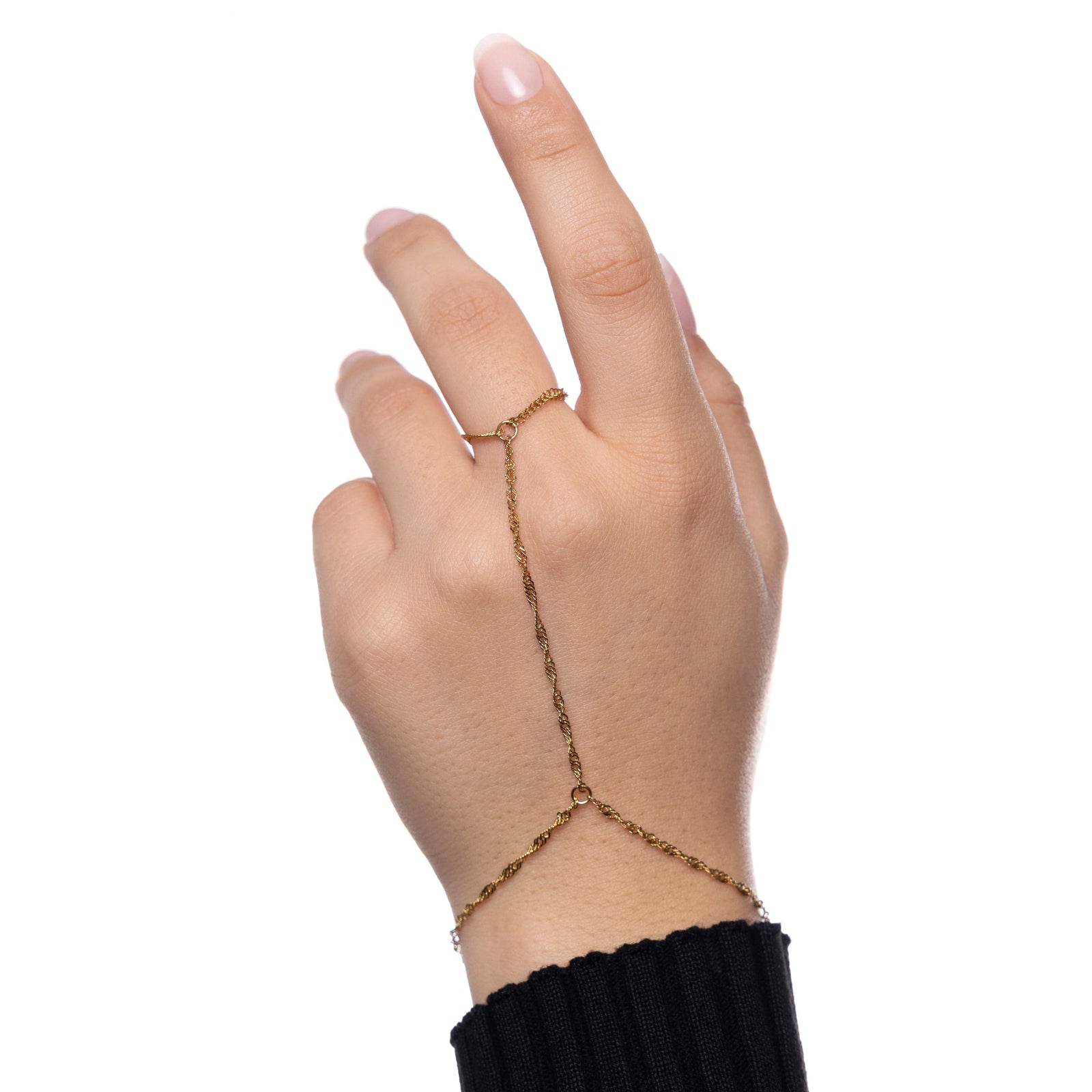 Back of hand wearing gold twisted hand chain against a white background.