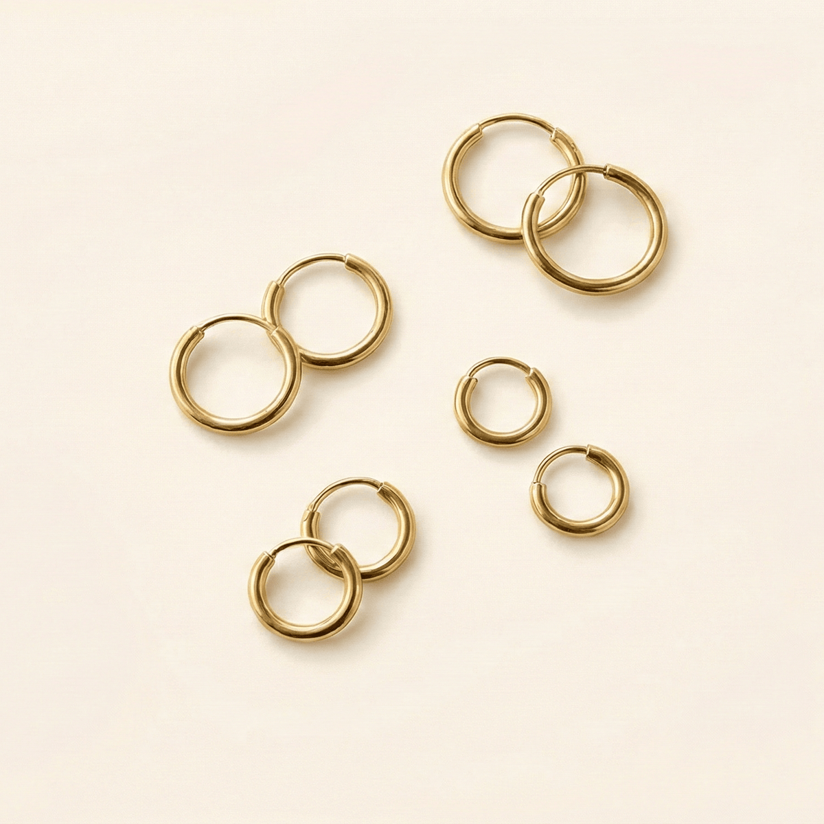 Four pairs of the gold mini hoops in different sizes.