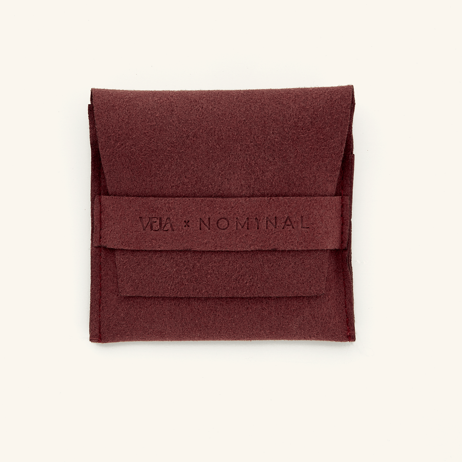 The Damask Rose Crescent Necklace presented in a Nominal branded velvet drawstring pouch, emphasizing the elegant and protective packaging accompanying the jewelry piece.