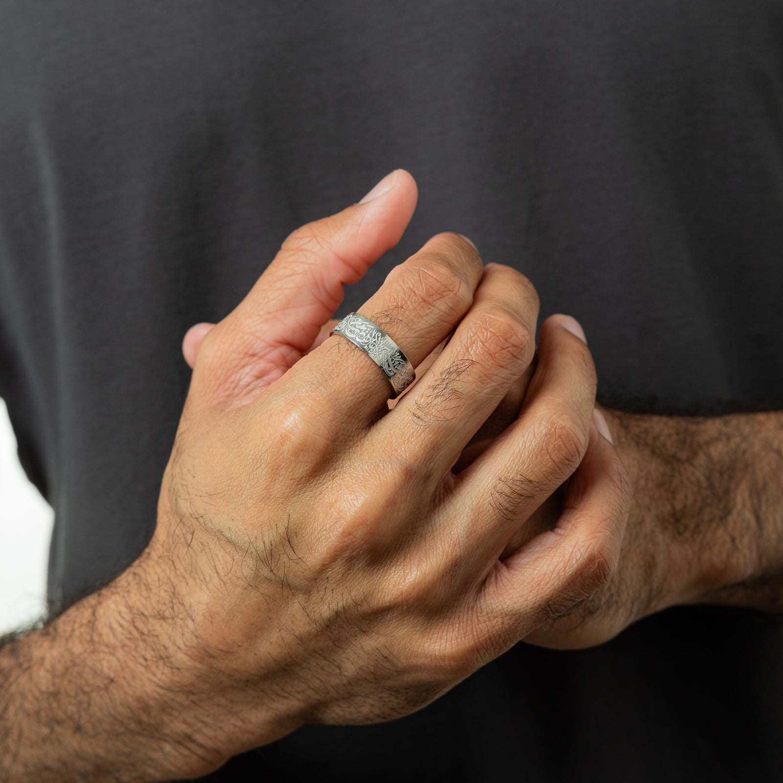Photo of the model's hands. The model is wearing the "With Hardship Comes Ease" Ring V2 | Men on their right index finger.