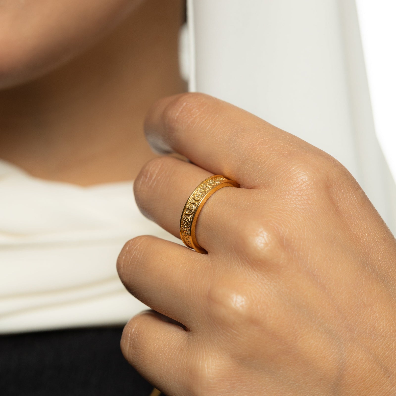 Gold vintage royalty ring on a woman's finger