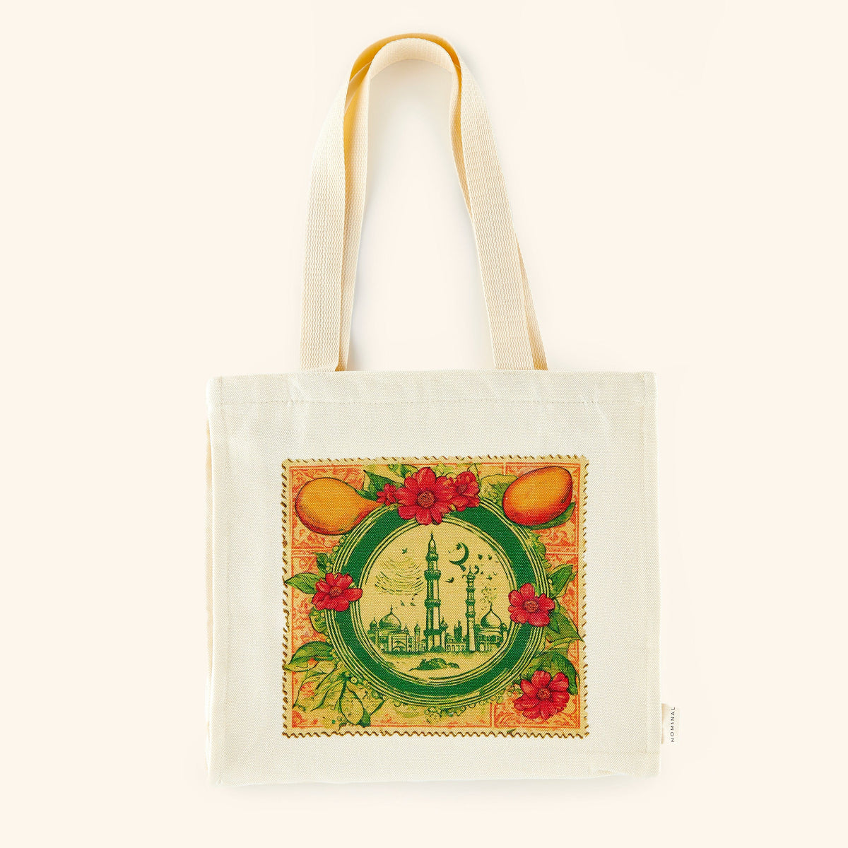 Photo of a beige tote bag that is  designed with a colorful print reminiscent of a vintage stamp, adorned with architecture from Pakistan, fruits and flowers, and other elements to bring a beautiful collage together. 