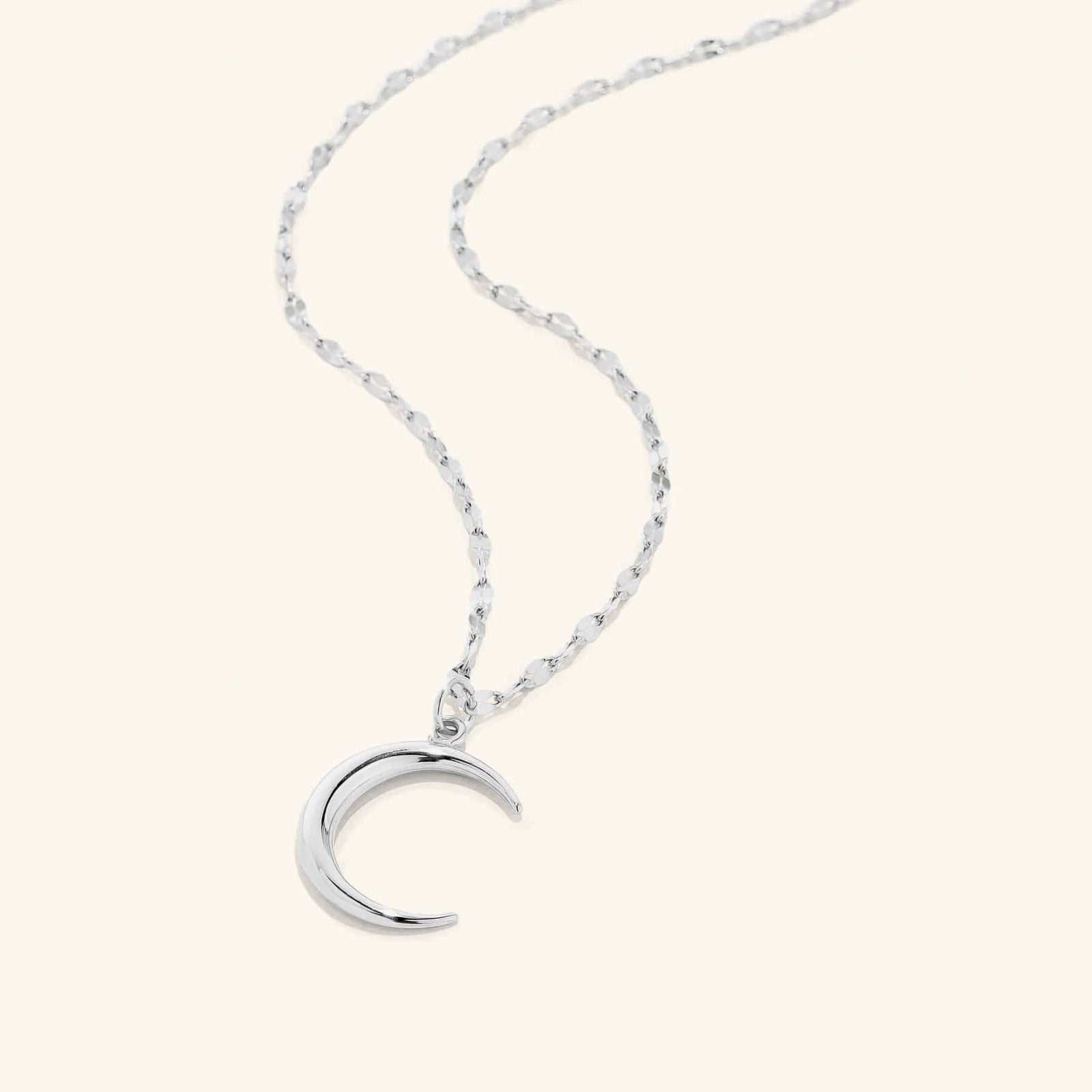 Flat lay of the silver Premium Crescent that offers a unique design that stays true to the sentiment of the classic predecessor, but with an elegantly softer 3D mold and a brand new chain 