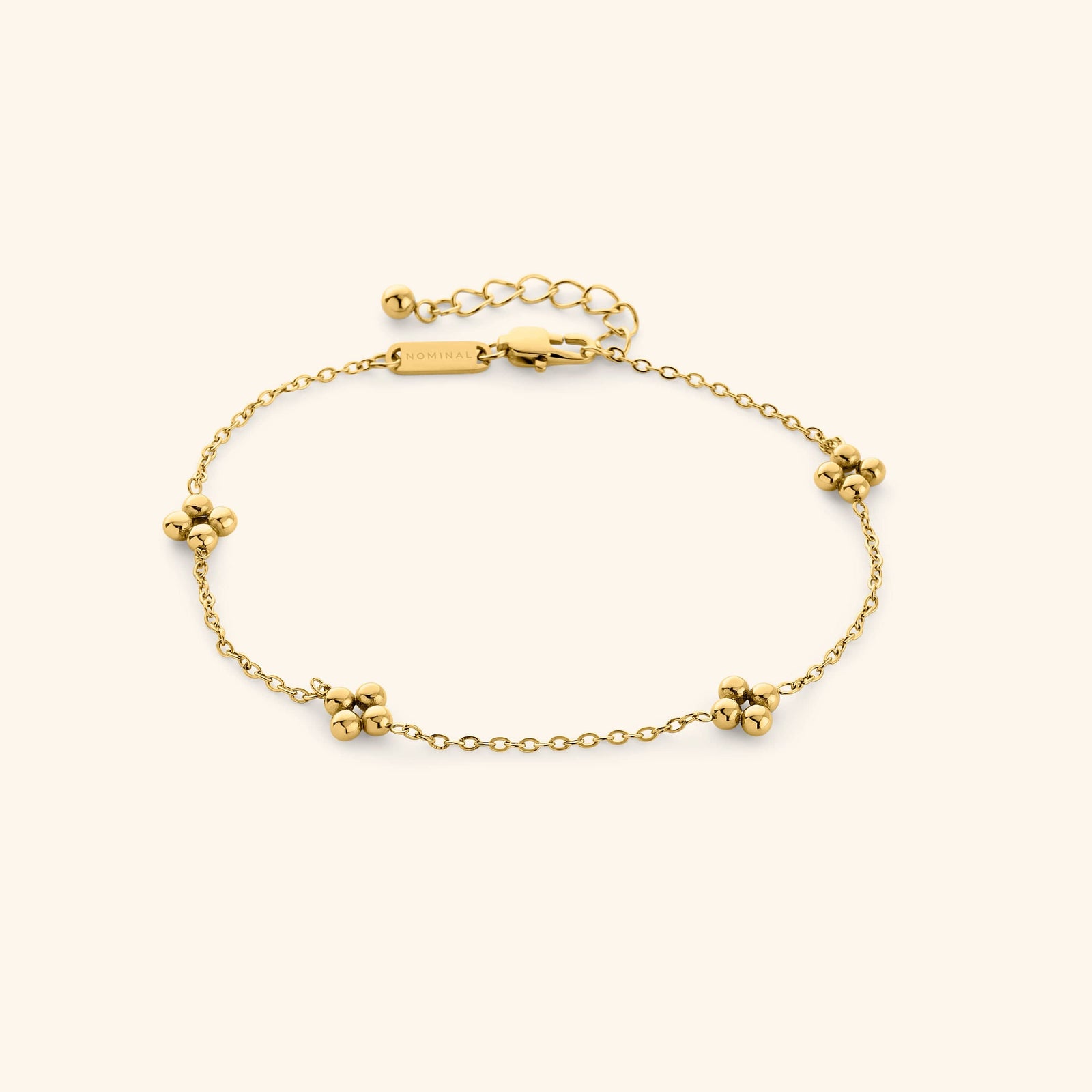 Gold Dotted Henna Anklet shot on a cream background, featuring a delicate chain with evenly spaced dotted floral clusters and adjustable clasp.