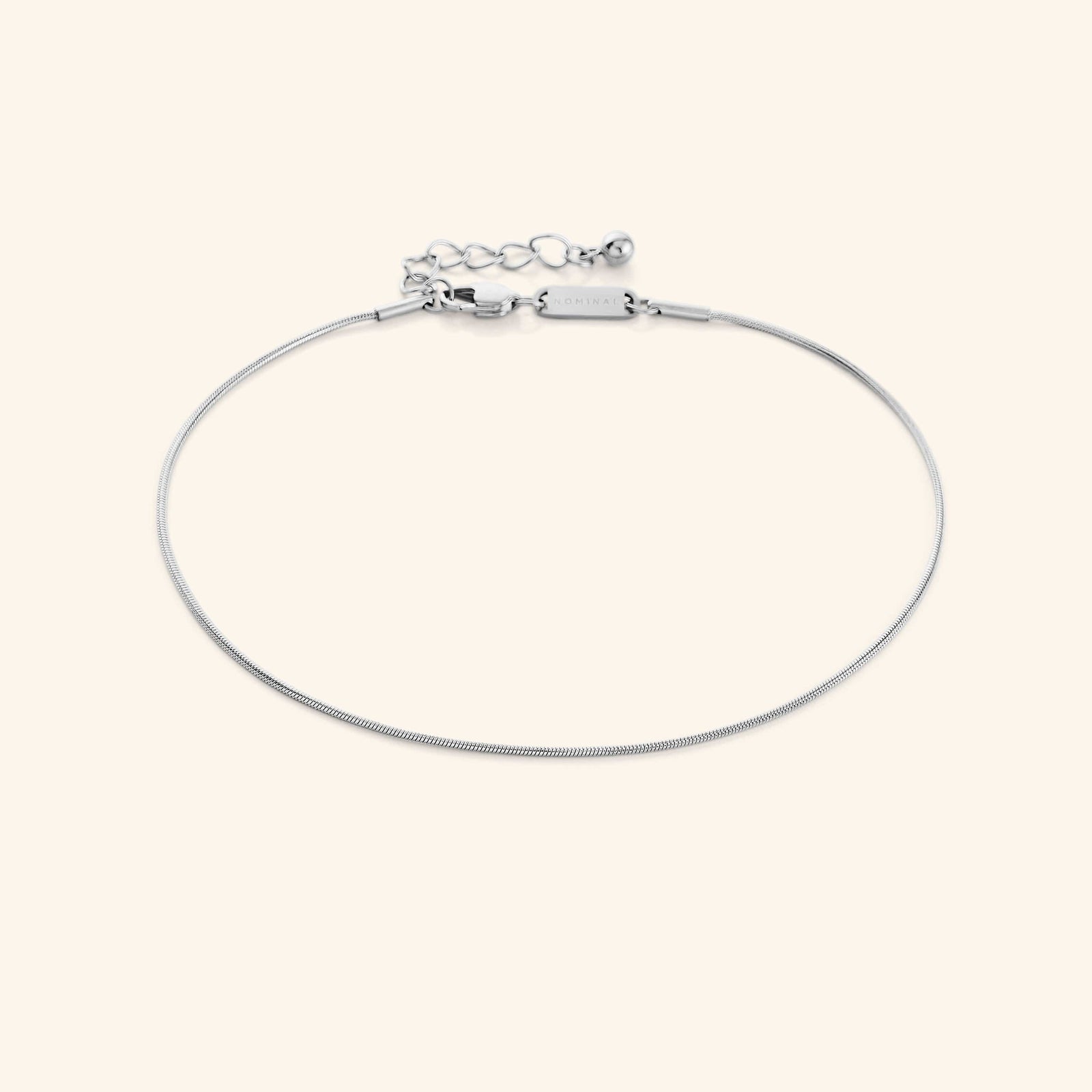 Photo of the silver Micro Harmony Anklet against a light background. This anklet features a 1MM seamless snake-like chain pattern