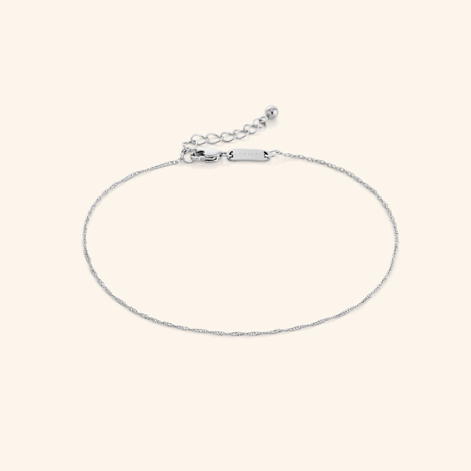 Photo of the silver Micro Twisted Anklet against a light background. This anklet features a 1MM twirling chain pattern.