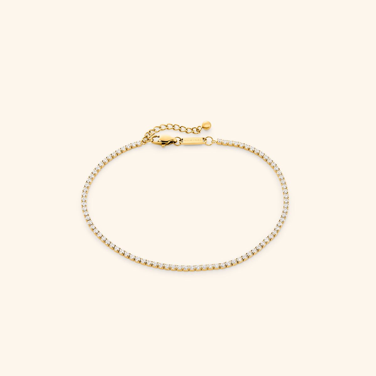18k gold-plated Tennis Anklet featuring a continuous strand of round clear crystals with an adjustable extension chain.