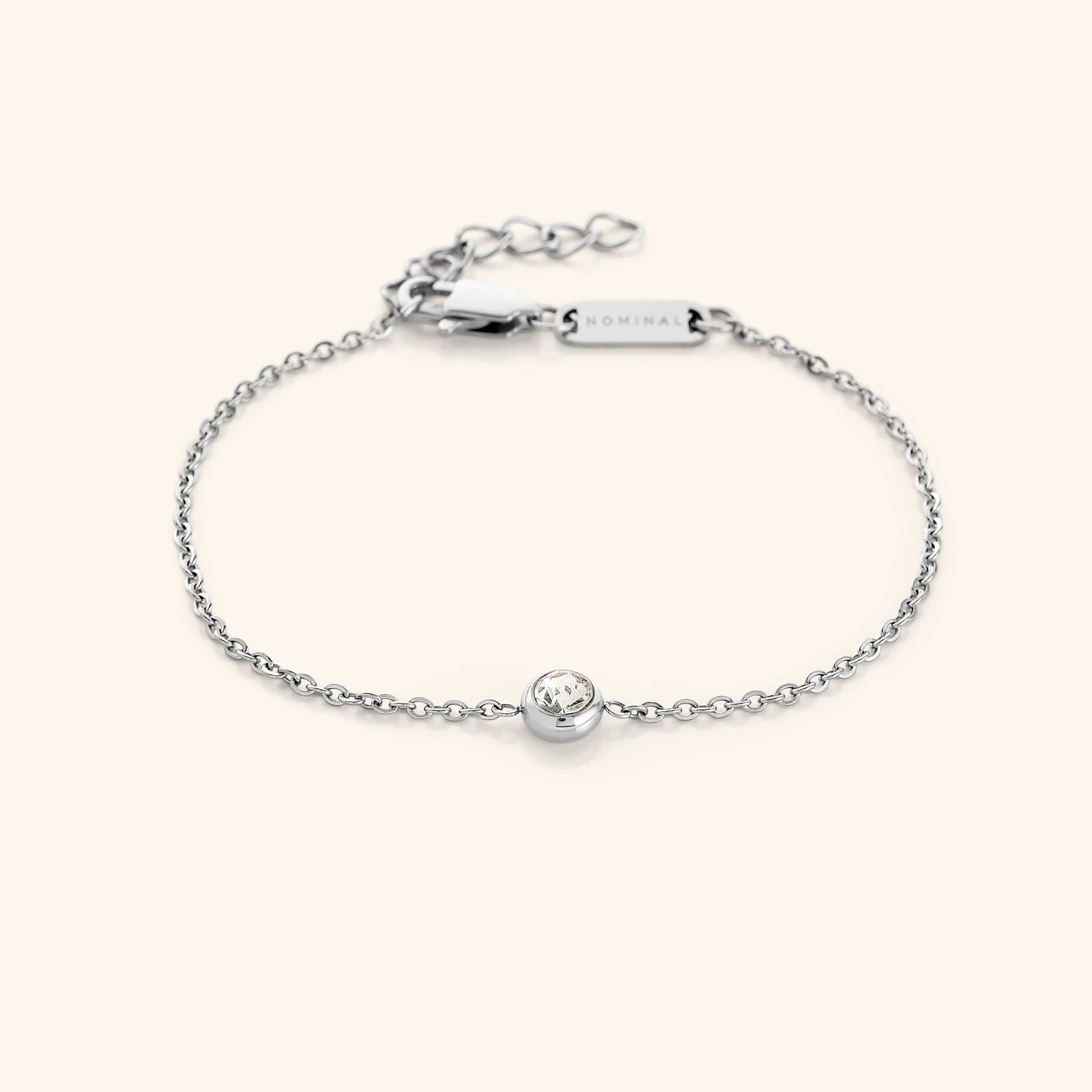 Flat lay of the silver bracelet. Marked by a minimal gemstone, our all new Bezel Bracelet features a beautiful finish that delivers an elegant piece to your wardrobe for any day, any occasion.
