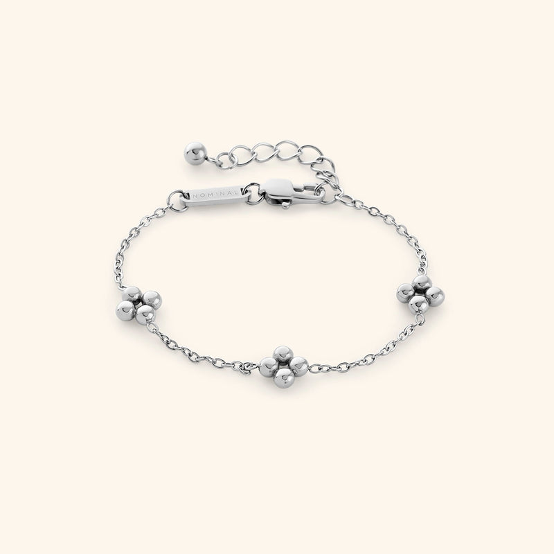 Close-up of the silver henna bracelet with three clusters of small round beads and an adjustable clasp engraved with “NOMINAL.”