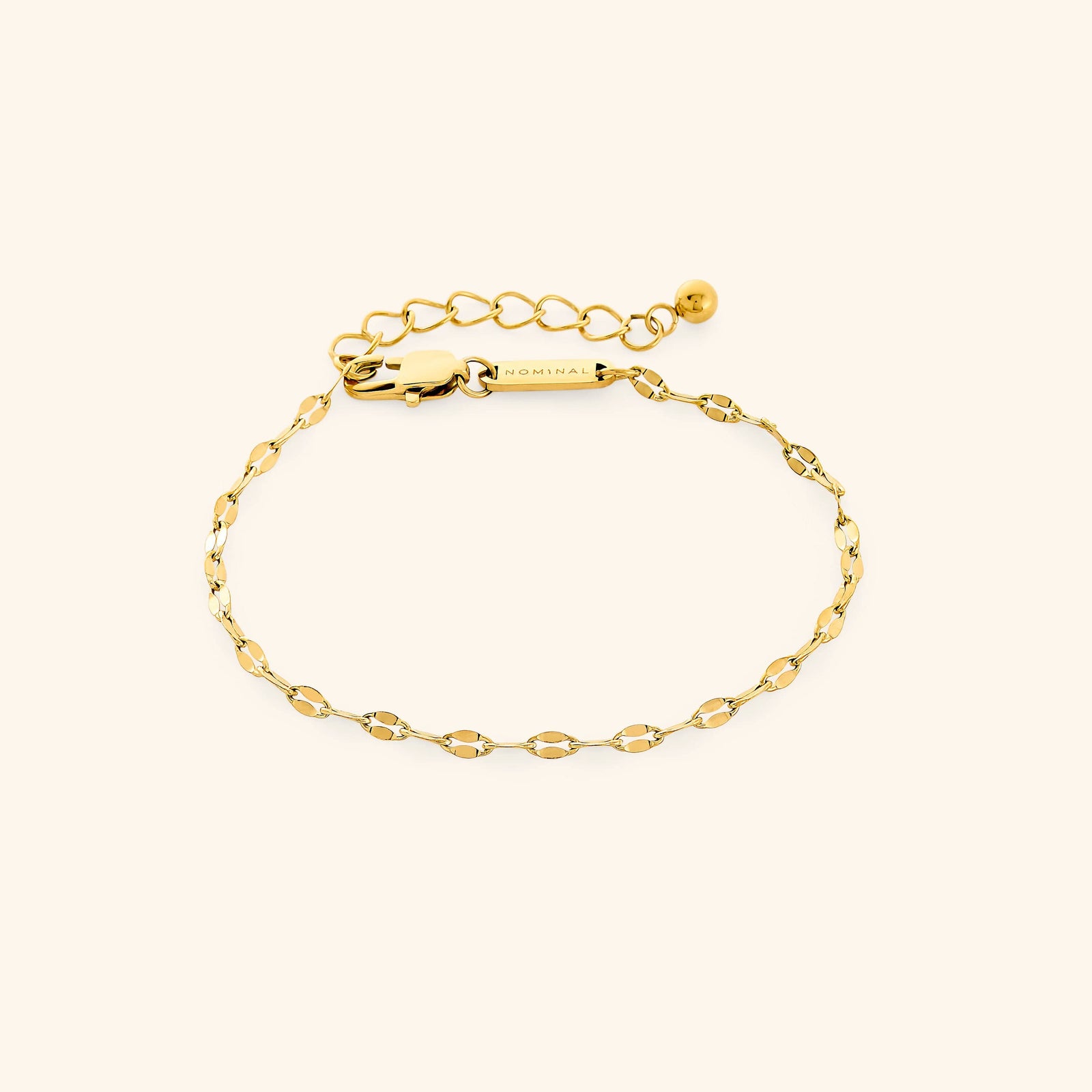 Flat lay of gold flutter chain bracelet with extender chain.