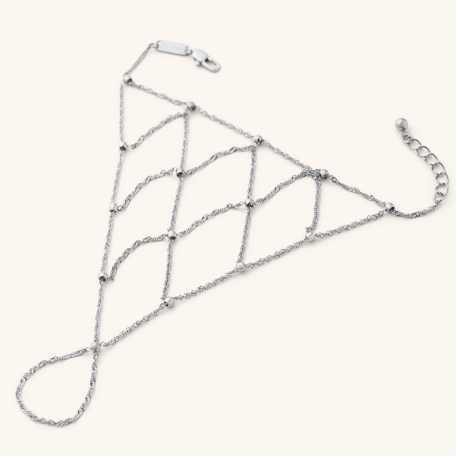 Silver Keffiyeh Fishnet Hand Chain with a lattice-style chain pattern and small bead accents.