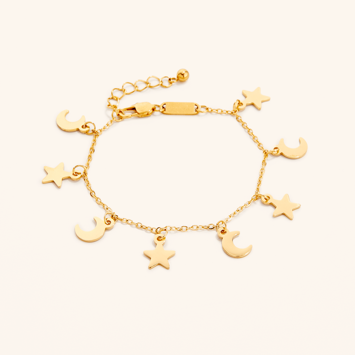 Photo of an 18k gold plated bracelet that features charms in star and crescent moon shapes.