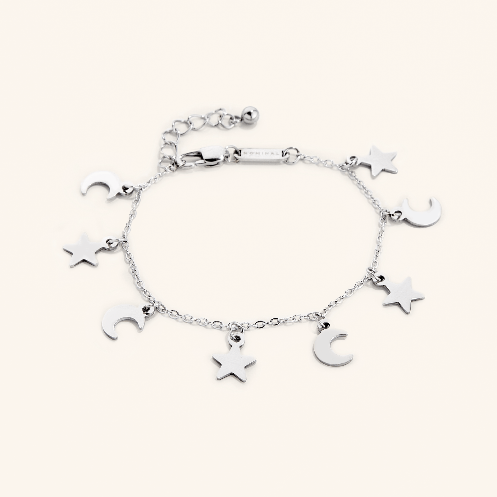 Photo of a silver bracelet that features charms in star and crescent moon shapes.