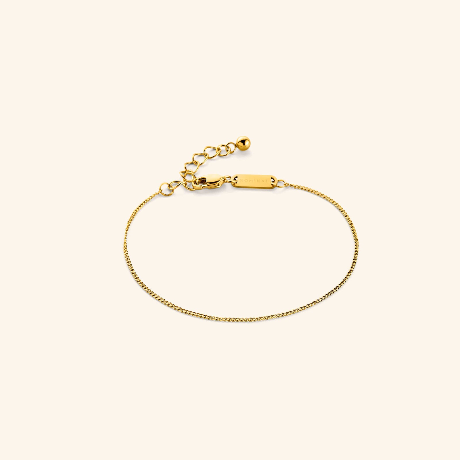 Photo of the gold Micro Curb Bracelet against a light background. This bracelet features a 1MM flat oval chain pattern.