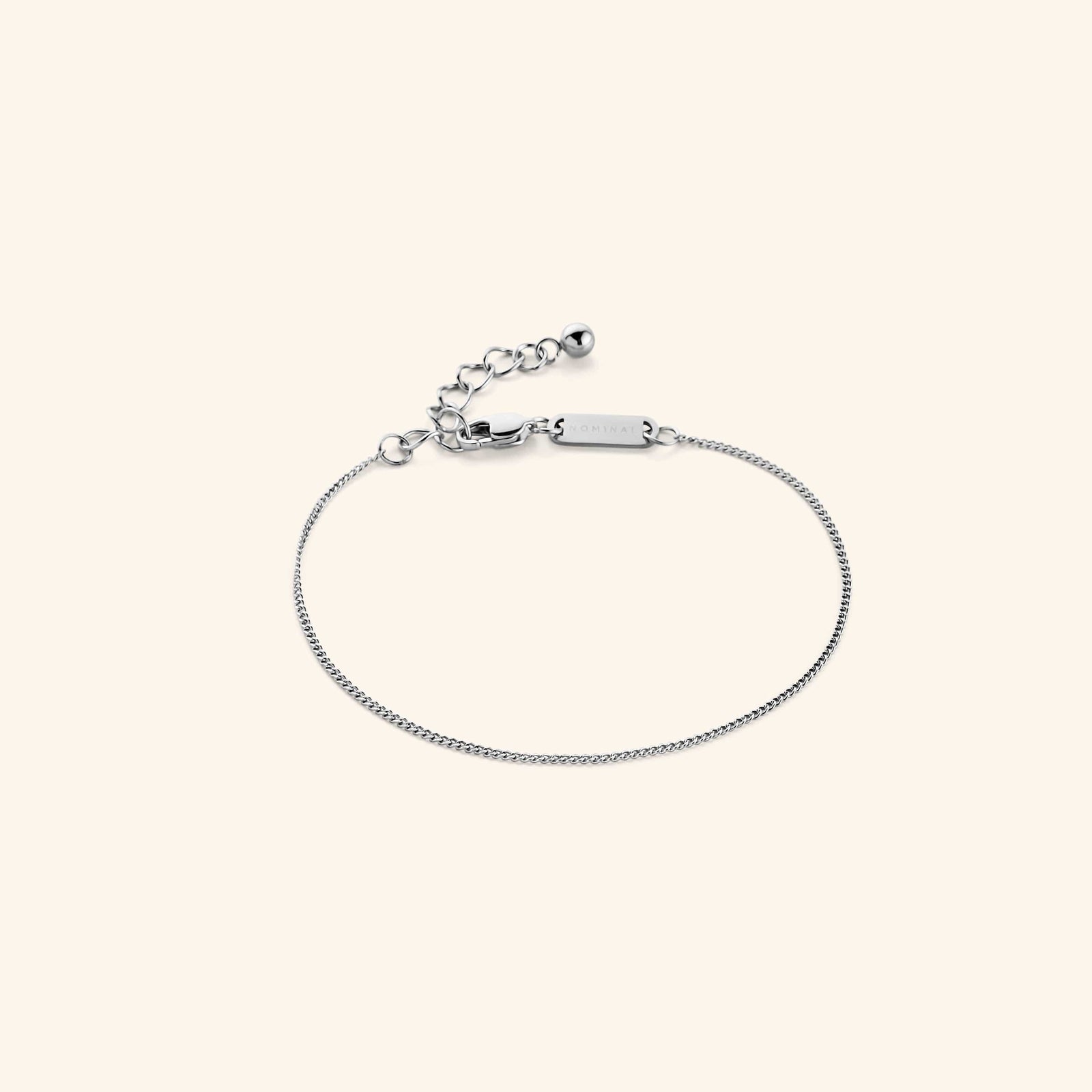 Photo of the silver Micro Curb Bracelet against a light background. This bracelet features a 1MM flat oval chain pattern.
