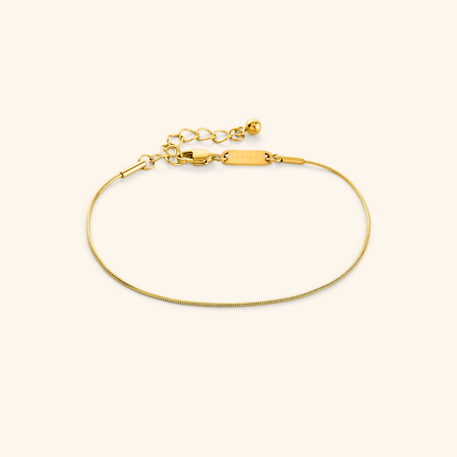 Photo of the gold Micro Harmony Bracelet against a light background. This bracelet  features a 1MM seamless snake-like chain 