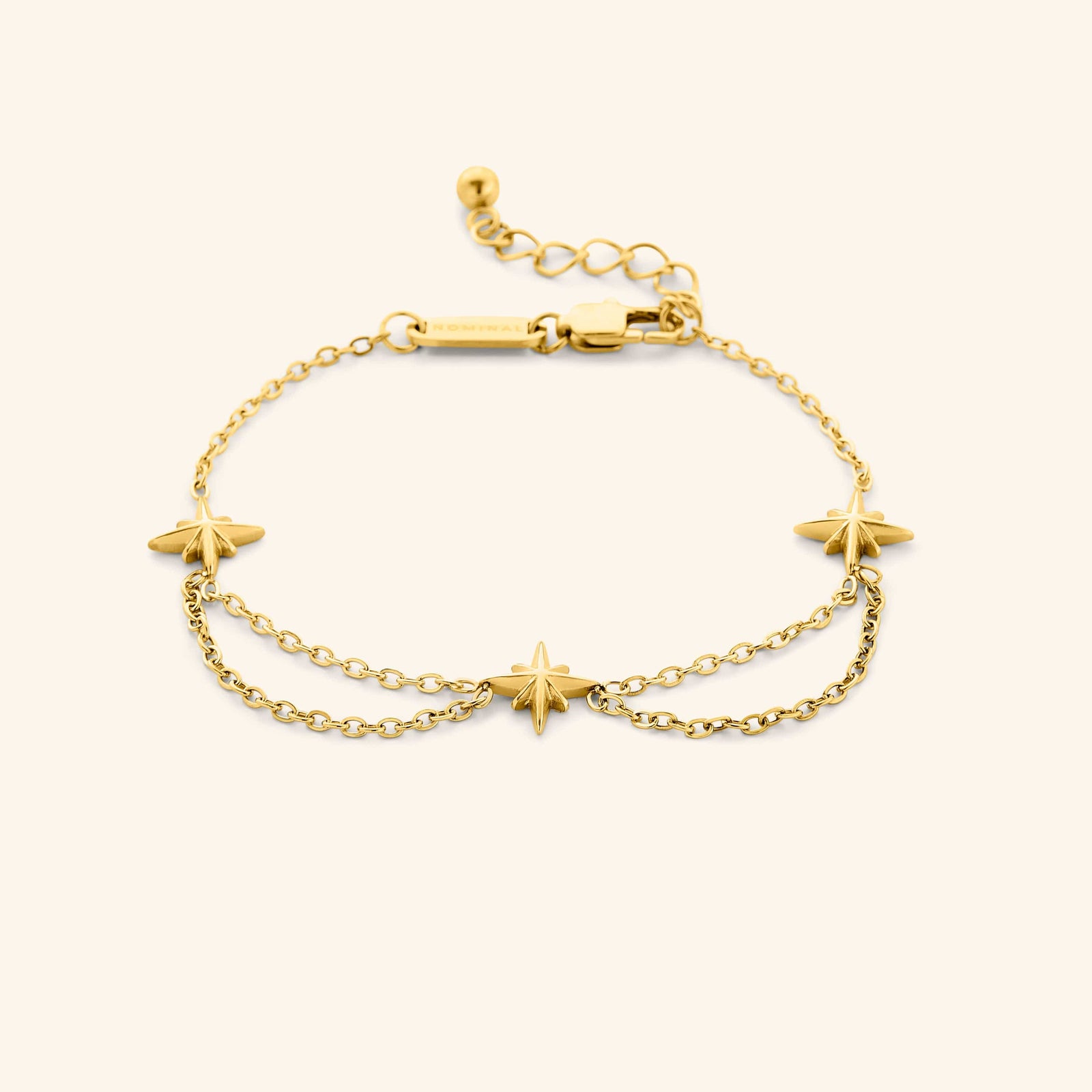 An 18k gold plated bracelet that features north stars all along the chain, drooping chains connecting each one design.