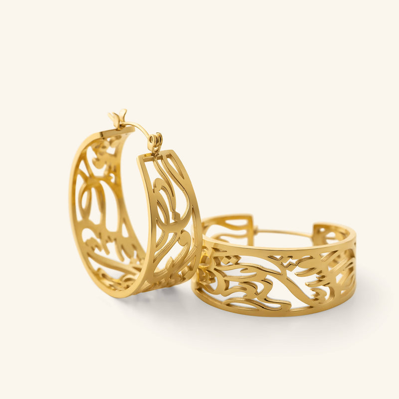 Close-up of the gold “Allah does not burden a soul beyond what it can bear” Earrings featuring a wide open-cut hoop design with flowing Arabic calligraphy.