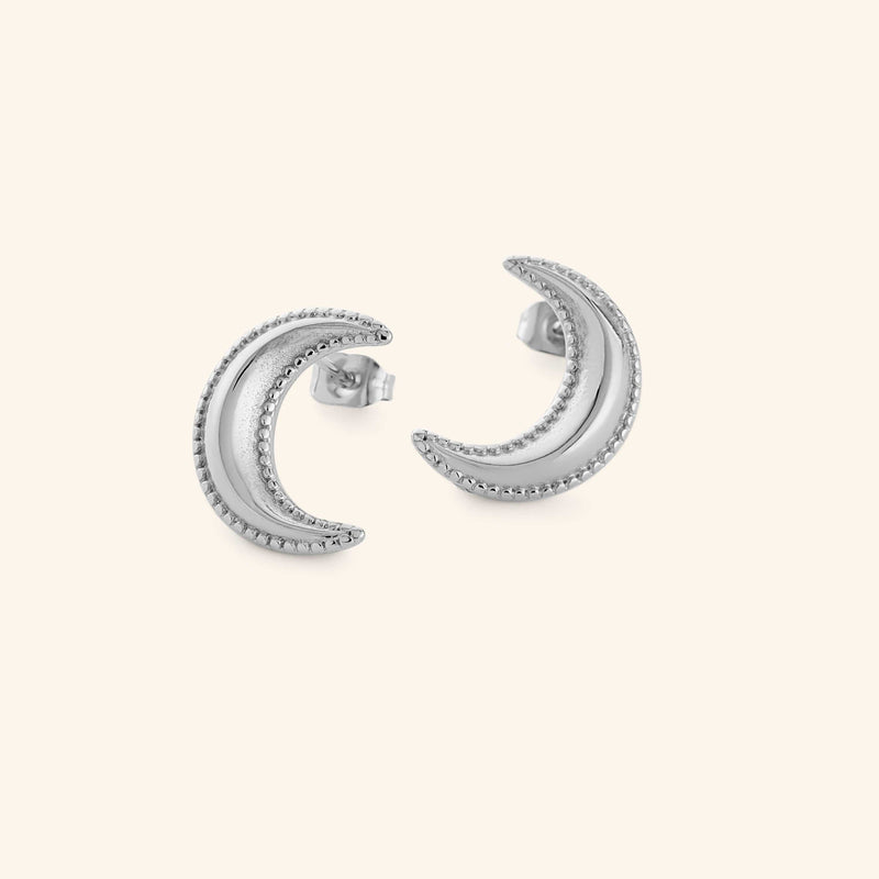 Silver crescent moon earrings with dotted design pimage_ shot on a white background