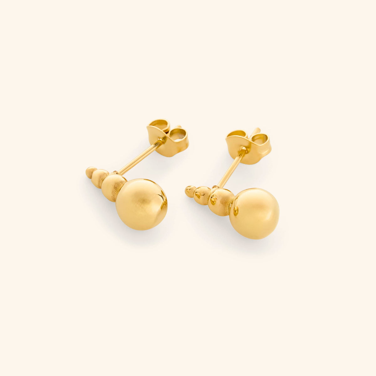 Close-up of the Dotted Studs in gold, featuring three stacked beads with a larger bead at the base.